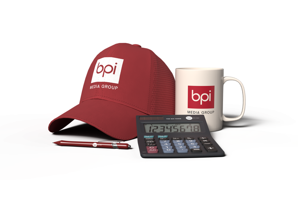 A baseball cap, coffee mug, ink pen, and calculator with the BPI Media Group logo on each of them.